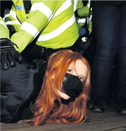  ?? JAMES VEYSEY ?? Clashes: A woman is arrested at a vigil in memory of murdered Sarah Everard (far left).