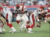  ?? RUSTY KENNEDY — THE ASSOCIATED PRESS FILE ?? Cincinnati Bengals’ Ickey Woods (30) carries the ball as teammates Bruce Reimers (75) and Rodney Holman (82) block during first-quarter action against the San Francisco 49ers in NFL football’s Super Bowl XXIII game in Miami, Fla.
