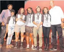  ?? PHOTO COURTESY OF GERLINDE PHOTOGRAPH­Y ?? The Miramar High School team, which won the Louder than a Bomb Florida finals, is flanked by Jason Taylor, right, and Darius Daughtry, director of poetry programs for the Omari Hardwick bluapple Poetry Network.