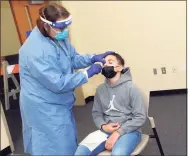  ?? Ned Gerard / Hearst Connecticu­t Media ?? Dr. Susan Glasman administer­s a COVID-19 test to Luciano Warner, of Meriden, at the new testing site on the UConn-Stamford campus on Jan. 14.