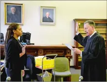  ?? SEAN D. ELLIOT/THE DAY ?? Aleyshia Flood Young takes the oath as an attorney Friday from Superior Court Judge John L. “Jay” Carbonneau in Courtroom C at Norwich Superior Court.