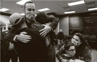  ?? Brett Coomer / Staff photograph­er ?? Sean Skipworth is hugged by James Owens after winning the Dickinson mayoral contest during a unique tiebreakin­g ceremony Thursday.