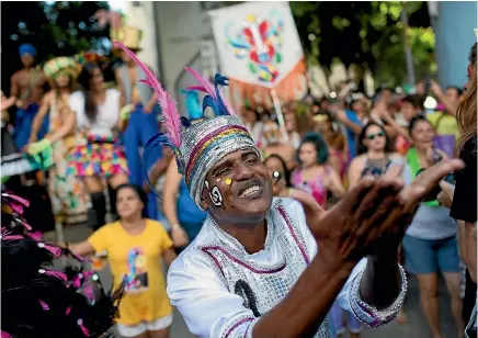  ?? AP ?? A patient from the Nise de Silveira mental health institute dances during the institute’s carnival parade, called ‘‘Loucura Suburbana’’, or Suburban Madness, in Rio de Janeiro yesterday before the official start of Carnival.