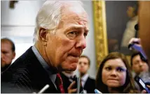  ?? JACQUELYN MARTIN / ASSOCIATED PRESS ?? Senate Majority Whip John Cornyn, R-Texas, listens to a question about the tax bill from a reporter as he leaves the Senate chamber Friday in Washington.