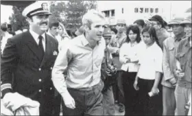  ?? HORST FAAS — THE ASSOCIATED PRESS FILE ?? U.S. Navy Lt. Cmdr. John McCain, center, is escorted by Lt. Cmdr. Jay Coupe Jr., to Hanoi, Vietnam’s Gia Lam Airport, after McCain was released from captivity.