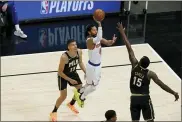  ?? BRYNN ANDERSON — THE ASSOCIATED PRESS ?? New York Knicks’ Derrick Rose (4) shoots against Atlanta Hawks’ Clint Capela (15) during the first half in Game 4of an NBA basketball first-round playoff series Sunday, May 30, 2021, in Atlanta.