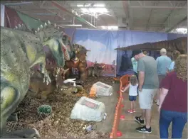  ?? Staff photo by Greg Bischof ?? ■ Vistors enjoy the display Sunday at the My Jurassic Adventure exhibit at the former Toys “R” Us building near Central Mall in Texarkana, Texas. An estimated 5,000 adult and 7,000 child dinosaur fans viewed the attraction over the weekend.