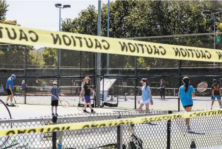  ?? Photos by Jessica Christian / The Chronicle ?? Children practice tennis skills at a day camp in Walnut Creek. Contra Costa County was briefly on the state’s virus watch list.