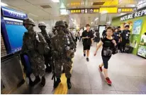  ?? Associated Press ?? n Passengers walk past army soldiers Aug. 22 during an anti-terror drill as part of Ulchi Freedom Guardian exercise inside a subway station in Seoul, South Korea. North Korea has vowed “merciless retaliatio­n” against U.S.-South Korean military drills.