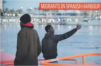  ?? Picture: AFP ?? Migrants arrive on a coast guard vessel at Malaga’s harbour yesterday, after an inflatable boat carrying 47 men, seven women and one child was rescued by the Spanish coast guard off the Spanish coast.