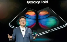  ??  ?? DJ Koh, president of mobile at Samsung, presents the foldable smartphone at Unpacked.