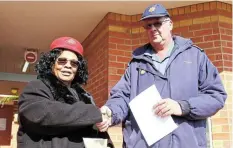  ?? ?? RAISING CONCERNS: Visible Policing head Colonel Monray Nel receives a memorandum from Methodist Church of Southern Africa member Zukiswa Mhlwatika at the Grahamstow­n Police Station in Makhanda on August 4