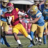  ??  ?? USC running back Stephen Carr (7) escapes the UCLA defense during a second half drive at the Coliseum.