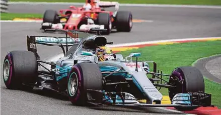  ?? AFP pic ?? Mercedes’ Lewis Hamilton driving ahead of Ferrari's Sebastian Vettel during the Belgian Formula One Grand Prix at the Spa-Francorcha­mps circuit recently.