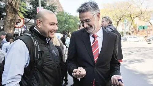  ?? Picture: Jacques Nelles ?? MORAL SUPPORT. Former South African Revenue Service officials Johann van Loggerenbe­rg, right, and Adrian Lackay leave the Hawks office in Pretoria, yesterday.