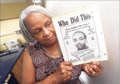  ?? Arnold Gold / Hearst Connecticu­t Media ?? Marlene Pratt holds a poster seeking informatio­n about the May 20, 1998, killing of her son, Gary Kyshon “Kiki” Miller.