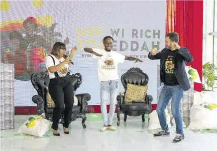  ??  ?? Jabbor Kayumov (right), Digicel Jamaica CEO, matches moves with dancehall sensation Laa Lee Ranks (centre), and Digicel Brand Ambassador Khadine ‘Miss Kitty’ Hylton, as they do the Digibounce dance during the launch of the company’s Mek Wi Rich Togeddah summer promotion, in downtown Kingston last week.