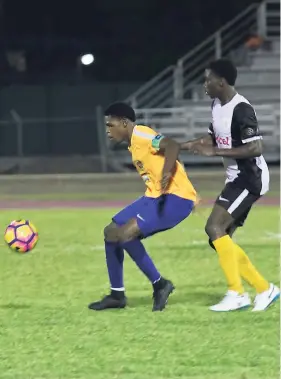  ?? ASHLEY ANGUIN ?? St Elizabeth Technical High’s Ronaldo Webster (left) shields the ball from Elian Jones during their ISSA Champions Cup match at the Montego Bay Sports Complex on Saturday, November 10. STETHS won 2-1 to progress to the semi-finals.