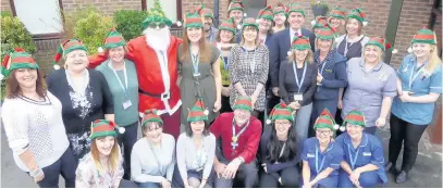  ??  ?? Staff from the hospice taking part in their own Elf Run with David Rutley, MP for Macclesfie­ld