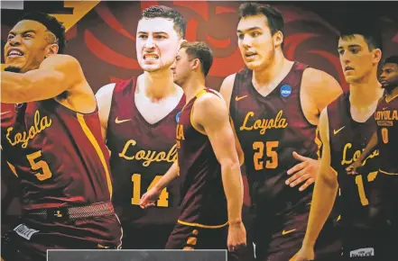  ?? RYNN ANDERSON/THE ASSOCIATED PRESS ?? Loyola-Chicago guard Ben Richardson, center, walks past a photo of himself for a practice session Friday in San Antonio.