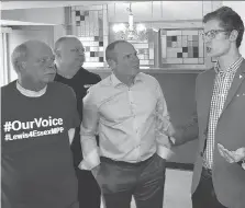  ?? CHRIS THOMPSON ?? Sam Oosterhoff, right, PC MPP for Niagara West-Glanbrook and youngest ever elected to a Canadian legislatur­e, chats with Essex PC nominee Chris Lewis and other party supporters Monday in Kingsville.