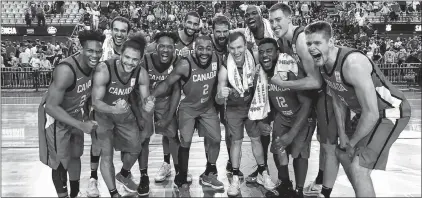  ?? BASKETBALL CANADA ?? Members of the Canadian men’s basketball team celebrate after a 94-67 win over Brazil Monday in Sao Paolo, a result that earned Canada a place in the 2019 World Cup of Basketball.