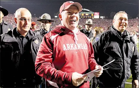  ?? Democrat-Gazette file photo ?? Bobby Petrino celebrates after Arkansas’ victory over LSU at Little Rock’s War Memorial Stadium in 2010. It was Petrino’s second victory against the Tigers as Arkansas’ head coach. The Razorbacks went on to play Ohio State in the Sugar Bowl in New...