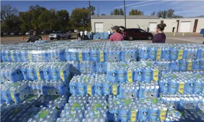  ?? ?? Volunteers distribute water in October at the Southwest Michigan Community Action Agency in Benton Harbor, Michigan. Photograph: Don Campbell/AP