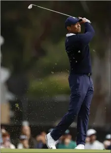  ?? AP PHOTO/RYAN KANG ?? Tiger Woods watches his shot from the fairway on the third hole during the first round of the Genesis Invitation­al golf tournament at Riviera Country Club, Thursday, Feb. 16, 2023, in the Pacific Palisades area of Los Angeles.