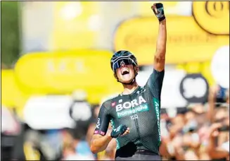  ??  ?? German Nils Politt celebrates as he crosses the finish line to win the twelfth stage of the Tour de France cycling race over 159.4 kilometers (99 miles) with start in Saint-Paul-Trois-Chateaux and finish in Nimes, France, on July 8. (AP)