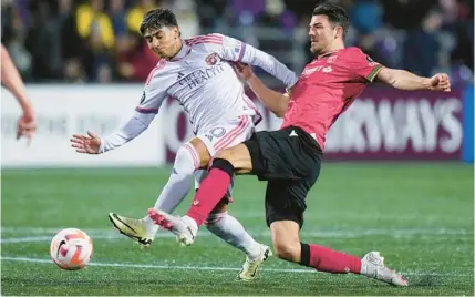  ?? THE CANADIAN PRESS ?? Orlando City’s Facundo Torres, left, scored twice last week in the Lions’ 3-0 Concacaf Champions Cup victory over Cavalry FC in Langford, British Columbia.