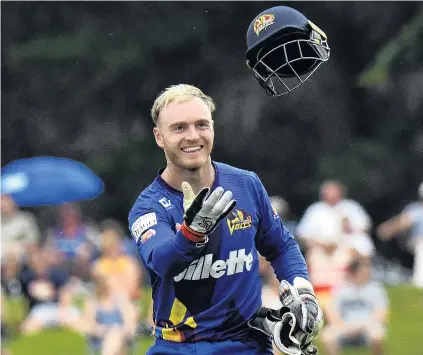  ?? PHOTO STEPHEN JAQUIERY ?? Hats off to him . . . Otago wicketkeep­er Ben Cox tosses his helmet to a player during the Super Smash game against Northern Districts at Molyneux Park, Alexandra, late last month.