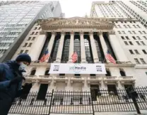  ?? AP PHOTO/JOHN MINCHILLO ?? A pedestrian passes the New York Stock Exchange in January. A huge shift is underway within the stock market, one that might roil your 401(k) in the short term, but one many profession­al investors also see leading to longer-lasting gains.