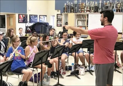  ?? PHOTO COURTESY OF JOHN ARMATO ?? New Pottstown High School band director David Bonilla-Garcia works on the new half-time show’s music during a recent rehearsal.