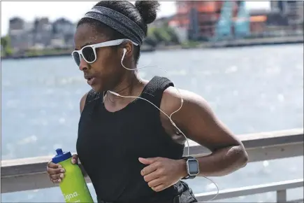  ?? JEENAH MOON / THE NEW YORK TIMES ?? A jogger runs in September at East River Park in New York. Being in shape may be as important to a long life as not smoking, according to a new study examining the links between fitness and mortality.