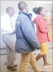  ?? (Pic:Melisa Msweli) ?? The two who were arrested for the mob justice along the pupil (not in picture) leaving court on Wednesday. They were with a plain-clothed police officer (behind).