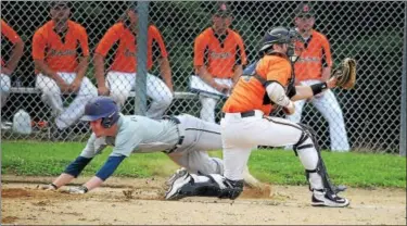  ?? GENE WALSH — DIGITAL FIRST MEDIA ?? Trooper’s Kyle Feaster slides into home for a run as Norristown catcher Bryan Mulhern fields the throw.