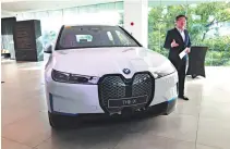  ?? ?? SMC Asia Car Distributo­rs Corp. (BMW Philippine­s) President Spencer Yu with the newly unveiled BMW iX