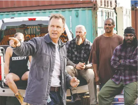  ?? CBS ?? Tough as Nails creator and host Phil Keoghan offers some advice to a handful of the new reality show’s dozen competitor­s.