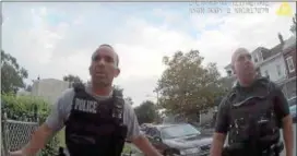 ?? SCREEN GRAB FROM BODYCAM FOOTAGE ACQUIRED BY OPEN RECORDS REQUEST ?? Trenton police officers chat as they process a scene where a handgun was found in the weeds inside a chain link fence.