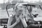  ?? BARBARA GAUNTT
The Clarion-Ledger via AP ?? Carol Poore, of Yazoo City, Miss., reacts to finding the sign to the family business on the ground Monday.