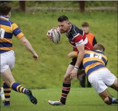  ??  ?? Wicklow’s Ben Armstrong is tackled by Monkstown’s Jack O’Neill.