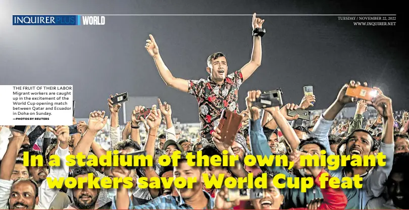  ?? —PHOTOS BY REUTERS ?? THE FRUIT OF THEIR LABOR Migrant workers are caught up in the excitement of the World Cup opening match between Qatar and Ecuador in Doha on Sunday.