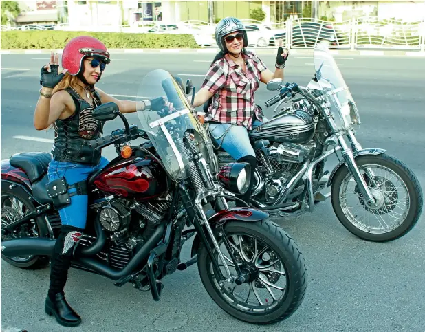  ??  ?? BIKE TEST: Dana Adam (left) and Sarah Momtaz give us the look during a photo shoot at Jumeirah. A number of women bikers have to hide the fact that they’re bikers from their families. Photo: Shihab