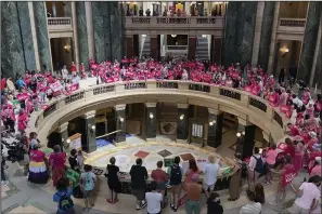  ?? (AP/Todd Richmond) ?? Dozens of protesters gather in the Wisconsin state Capitol rotunda on Wednesday in Madison, Wis., in hopes of convincing Republican lawmakers to repeal the state’s 173-year-old ban on abortions.