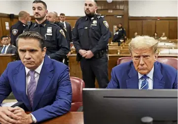  ?? ?? HUSH MONEY CASE: Donald Trump, right, sits in the courtroom alongside his attorney Todd Blanche yesterday as he awaits the start of criminal proceeding­s on the second day of jury selection at Manhattan Criminal Court in New York.