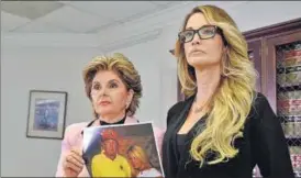  ?? REUTERS ?? Lawyer Gloria Allred (left) on Saturday holds a photograph of Jessica Drake and Donald Trump, taken in 2006 at a golf tournament in Lake Tahoe, California.