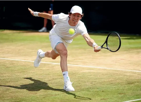  ??  ?? Australia’s John-Patrick Smith stretches to reach the ball in his loss to Kiwi Artem Sitak and American Nicholas Monroe at Wimbledon.