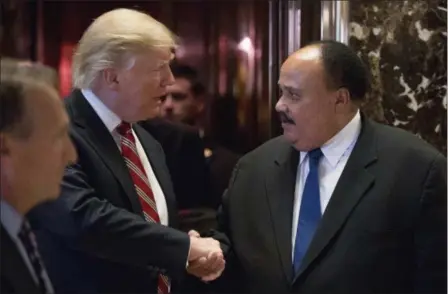  ?? ANDREW HARNIK — THE ASSOCIATED PRESS FILE ?? Donald Trump shakes hands with Martin Luther King III, son of Martin Luther King Jr. at Trump Tower in New York. King III, met with Trump on the last King holiday, four days before Trump took office. He spoke to the then-president-elect about the...