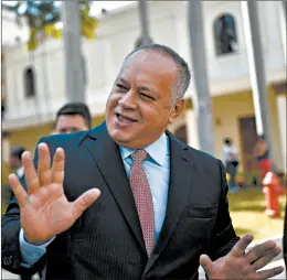  ?? MATIAS DELACROIX/AP ?? Socialist party president Diosdado Cabello jokes with lawmakers at the National Assembly in Caracas, Venezuela. Cabello announced last week that he has tested positive for COVID-19.